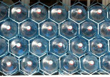 Jugs of water stacked in a rack